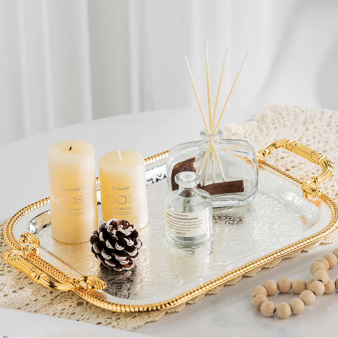 Elegant gold serving tray styled with candles and diffuser for home decor